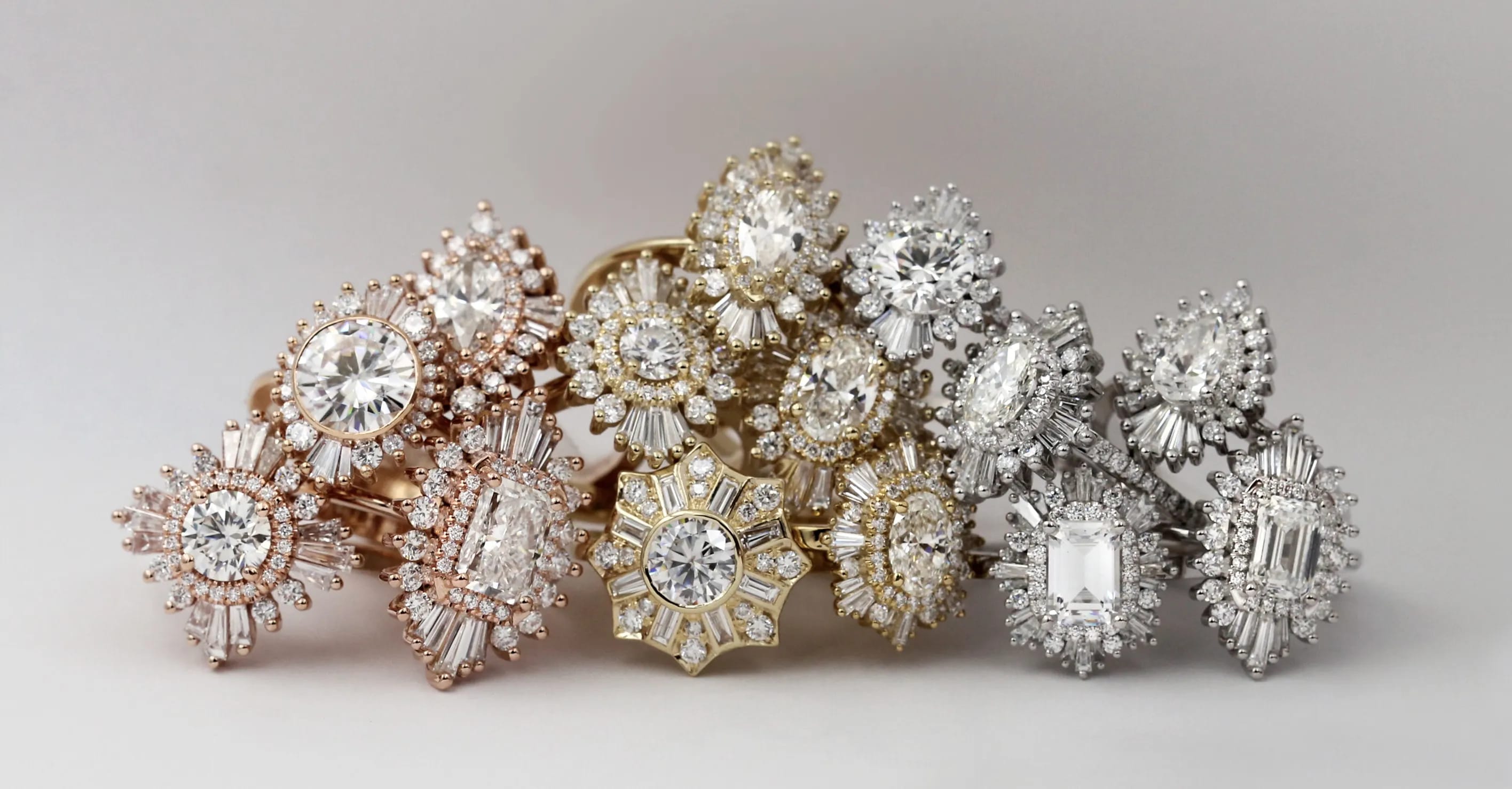 A photograph of a bunch of Heidi Gibson rings in yellow, white and rose gold metals.