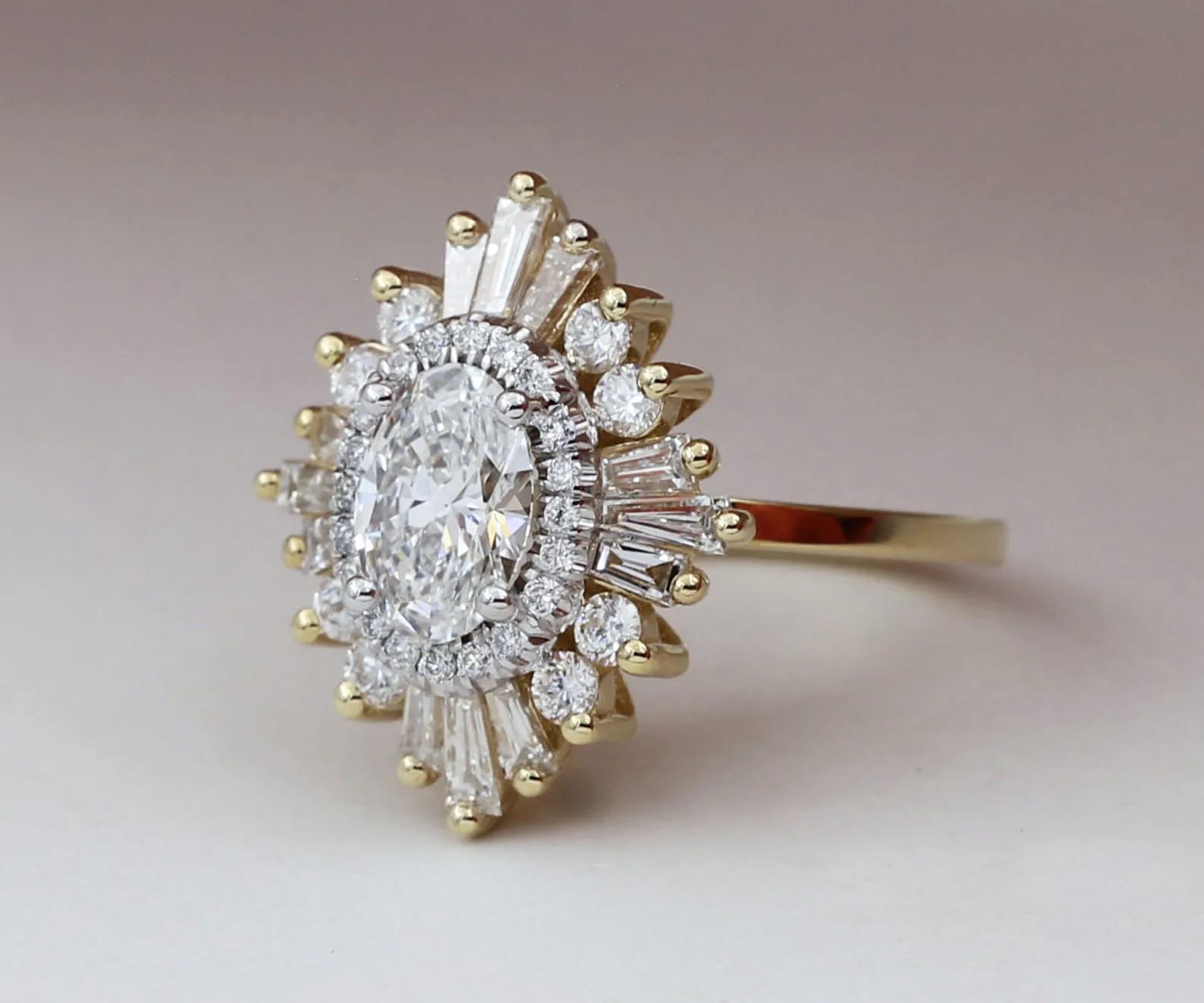 An oval Gatsby engagement ring in rose and yellow gold